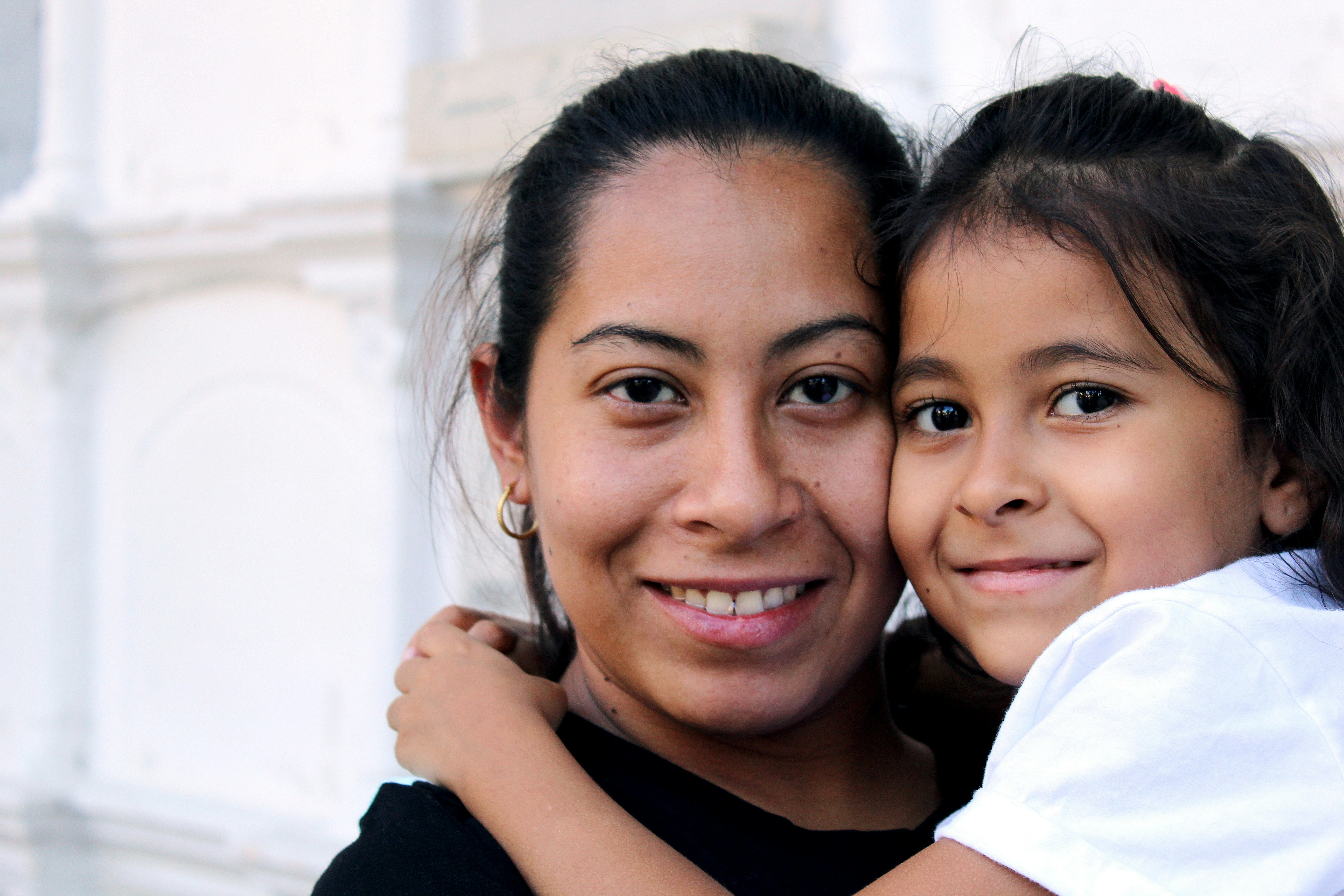 A smiling woman and her daughter